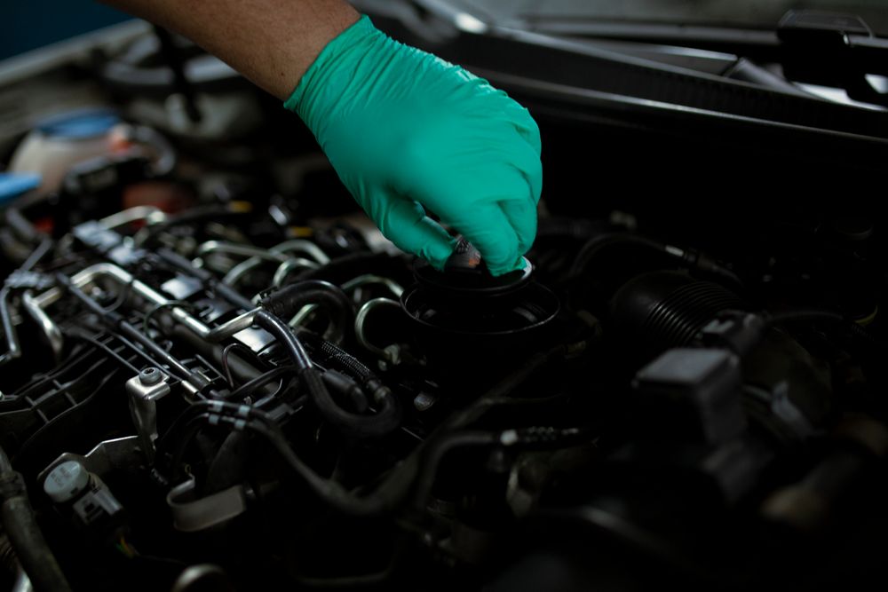 Mechanic opening an engine oil filler cap