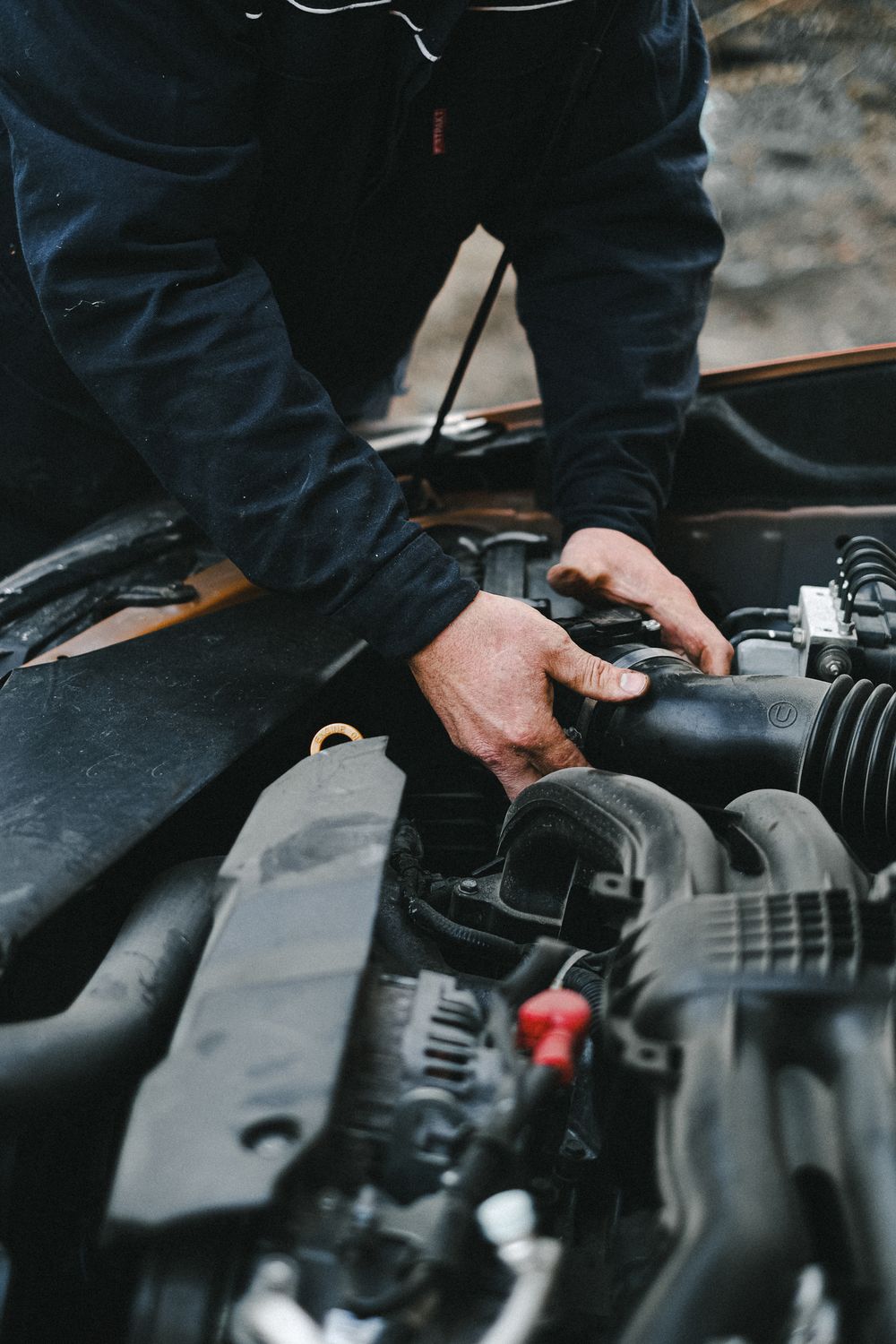 Technician working on a car engine